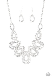 Delicately hammered in blinding shimmer, glistening silver bars spin into asymmetrical teardrops. The airy abstract frames link into a bold industrial statement piece below the collar. Features an adjustable clasp closure.