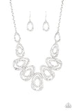 Delicately hammered in blinding shimmer, glistening silver bars spin into asymmetrical teardrops. The airy abstract frames link into a bold industrial statement piece below the collar. Features an adjustable clasp closure.