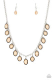 Infused with studded silver frames, round and oval brown beads swing from a shimmery silver chain, creating a colorful fringe below the collar. Features an adjustable clasp closure. Sold as one individual necklace.