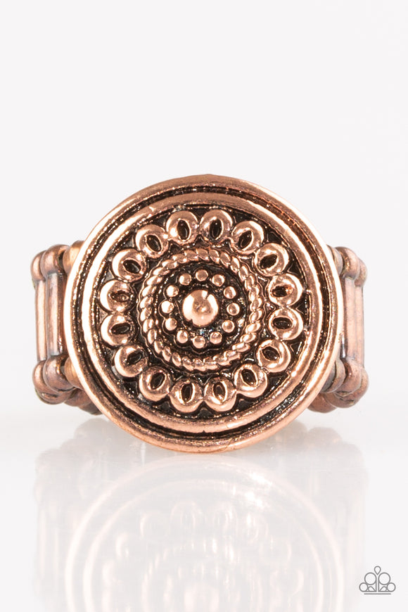 Embossed in a whimsical daisy pattern, a round copper frame sits atop the finger for a seasonal look. Features a stretchy band for 