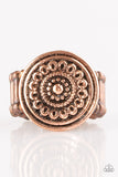 Embossed in a whimsical daisy pattern, a round copper frame sits atop the finger for a seasonal look. Features a stretchy band for 