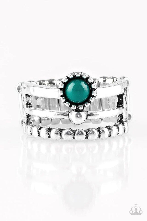 Featuring smooth, hammered, and dotted surfaces, three glistening silver bands stack across the finger. A dainty green bead is pressed into the center of the uppermost band, adding a colorful finish to the seasonal palette. Features a stretchy band for a flexible fit. 