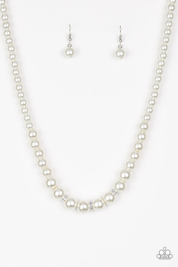 Gradually increasing in size near the center, a strand of luminescent white pearls falls just below the collar. White rhinestone encrusted rings are sprinkled along the center for a timeless finish. Features an adjustable clasp closure.  Sold as one individual necklace. Includes one pair of matching earrings.