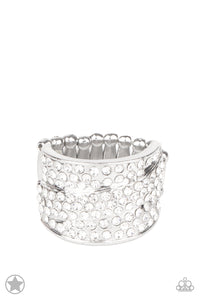 Row upon row of glistening white rhinestones stack into an incandescent display. An additional row of sparkling rhinestones wraps diagonally across the band for an extra splash of refined shimmer. Features a stretchy band for a flexible fit.