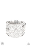Row upon row of glistening white rhinestones stack into an incandescent display. An additional row of sparkling rhinestones wraps diagonally across the band for an extra splash of refined shimmer. Features a stretchy band for a flexible fit.