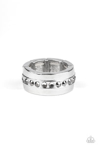 A single row of glassy hematite rhinestones is encrusted along the center of a thick silver band. Features a stretchy band for a flexible fit.