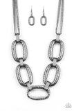 Delicately hammered in blinding shimmer, oversized shiny gunmetal chain links and textured fittings connect below the collar. Suspended from strands of gunmetal chains, the bold links catch and reflect the light for a statement-making finish. Features an adjustable clasp closure.
