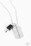 Pinched between a black leather fitting, a silver bullet pendant joins a silver dog tag at the bottom of a silver ball chain. The shimmery dog tag is stamped in the phrase, "Because of the Brave," for a patriotic finish. Features a ball and clasp closure.