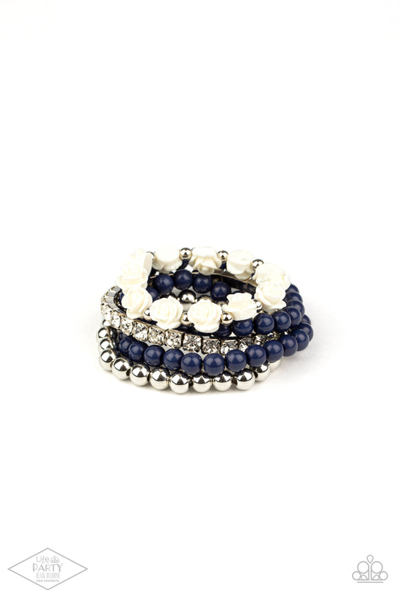 A vintage inspired collection of ivory resin roses, navy beads, and classic silver beads join a stretchy band of glittery white rhinestones dotted around the wrist for a flawlessly stacked look.