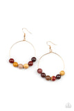An oversized collection of earthy stones slide along the bottom of a dainty gold hoop, creating an earthy centerpiece. Earring attaches to a standard fishhook fitting