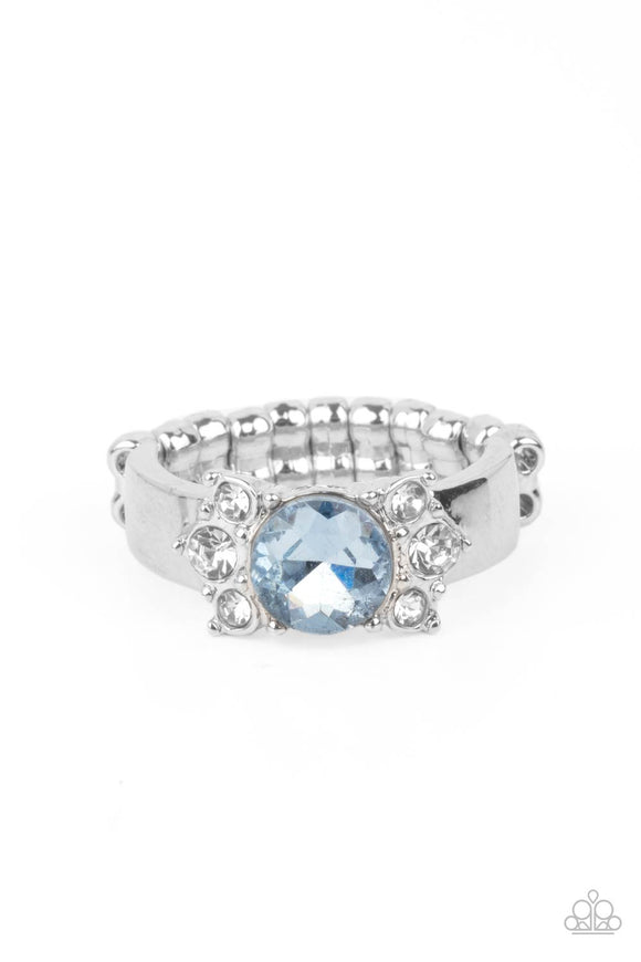 Trios of glassy white rhinestones flank an oversized Cerulean rhinestone, creating a sparkly centerpiece atop a dainty silver band. Features a dainty stretchy band for a flexible fit.