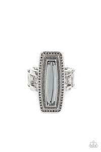 An elongated smoky gem is pressed into the center of a studded silver frame atop layered silver bands, creating a stellar centerpiece atop the finger. Features a stretchy band for a flexible fit.