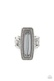 An elongated smoky gem is pressed into the center of a studded silver frame atop layered silver bands, creating a stellar centerpiece atop the finger. Features a stretchy band for a flexible fit.