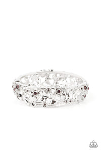 Dotted with dainty purple rhinestone centers, flowering leafy silver vines bloom into two oversized silver frames that delicately hinge into a versatile bangle-like bracelet. Features a hinged closure.