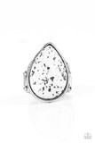 A generous polished white stone infused with black flecks is encased in a simple silver teardrop frame resulting in a seasonal finish atop the finger. Features a stretchy band for a flexible fit.