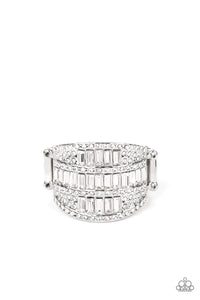 The front of a silver oval frame is encrusted in stacked rows of emerald and round cut white rhinestones, coalescing into a blinding centerpiece atop the finger. Features a stretchy band for a flexible fit.<br data-mce-fragment="1">