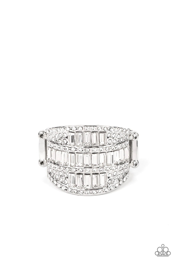 The front of a silver oval frame is encrusted in stacked rows of emerald and round cut white rhinestones, coalescing into a blinding centerpiece atop the finger. Features a stretchy band for a flexible fit.<br data-mce-fragment=
