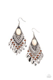 An earthy fringe of dainty wooden beads and oval silver discs trickles from the bottom of an ornate silver frame that is dotted in an oval white stone for a seasonal flair. Earring attaches to a standard fishhook fitting.  Sold as one pair of earrings.