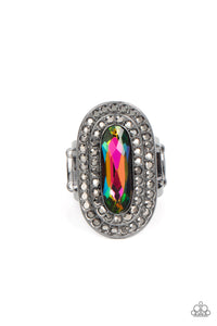 An elongated sparkling oil spill gem is nestled inside a linear hematite frame created by double rows of dainty smoky rhinestones. The faceted gem creates a glamorously edgy effect atop the finger. Features a stretchy band for a flexible fit.