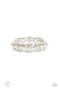 Iridescent rhinestone encrusted silver bars flank a dazzling trio of oversized iridescent rhinestones, coalescing into a glittery frame. The sparkly frames are threaded along stretchy bands around the wrist, creating an irresistible shimmer.