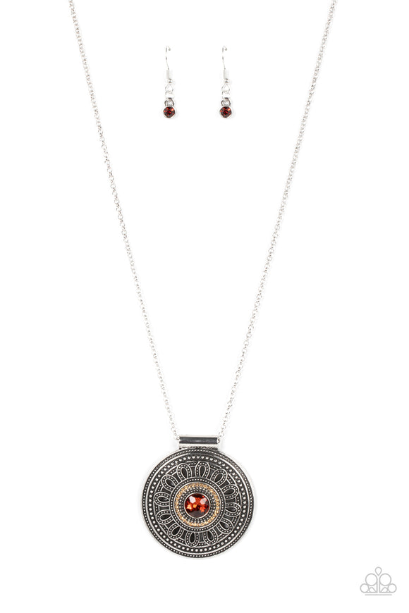 Encircled in a dainty ring of golden topaz rhinestones, an oversized topaz rhinestone is pressed into the center of a silver medallion that is abloom with a studded floral motif. The flowery pendant glides along an extended silver chain, resulting in a radiant pendant. Features an adjustable clasp closure.