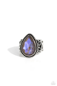 Featuring an iridescent UV finish, an oversized brown teardrop gem is pressed in the center of a textured silver frame atop a thick silver band whirling with silver filigree. Features a stretchy band for a flexible fit. Due to its prismatic palette, color may va