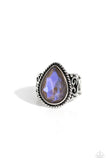 Featuring an iridescent UV finish, an oversized brown teardrop gem is pressed in the center of a textured silver frame atop a thick silver band whirling with silver filigree. Features a stretchy band for a flexible fit. Due to its prismatic palette, color may va