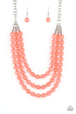 Attached and separated by shiny silver beads, three rows of alternating coral striped acrylic beads layer across the collar creating a colorful canvas. Features an adjustable clasp closure.