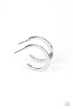 A deceptively simple hoop of silver smoothly curves around the ear. The flattened surface of the hoop catches the light, emitting radiant shimmer from the crescent-shaped curves. Earring attaches to a standard post fitting. Hoop measures approximately 3/4" in diameter.