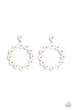 Hanging from a solitaire white daisy, a dainty collection of white daisies bloom into a free-spirited wreath below the ear. Gold studs gleam from the centers of the tactile flowers, adding an industrial sheen to the display. Earring attaches to a standard post fitting.