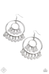 Silver discs, hammered with studded details, trickle from the bottom of an oversized sleek silver hoop, creating an elegant lure. A smaller hoop with a similar sheen, swings from the top of the oversized hoop, which features even more dangling discs for additional eye-catching movement. Earring attaches to a standard fishhook fitting.