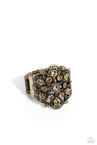 Sporadically dotted on a whimsically, intricate brass frame, light colored topaz rhinestones seemingly form into a delicate flower atop the finger for a refined centerpiece. Features a stretchy band for a flexible fit.
