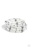 Pearly white seed beads, and various-sized silver accents are threaded along a coiled wire, creating a refined infinity wrap-style bracelet around the wrist.