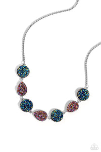 Featuring blue oil spill and UV amethyst druzy-like accents, round and teardrop silver frames alternate from a rounded box chain down the neckline for a jaw-dropping finish. Features an adjustable clasp closure. Due to its prismatic palette, color may vary.