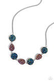 Featuring blue oil spill and UV amethyst druzy-like accents, round and teardrop silver frames alternate from a rounded box chain down the neckline for a jaw-dropping finish. Features an adjustable clasp closure. Due to its prismatic palette, color may vary.